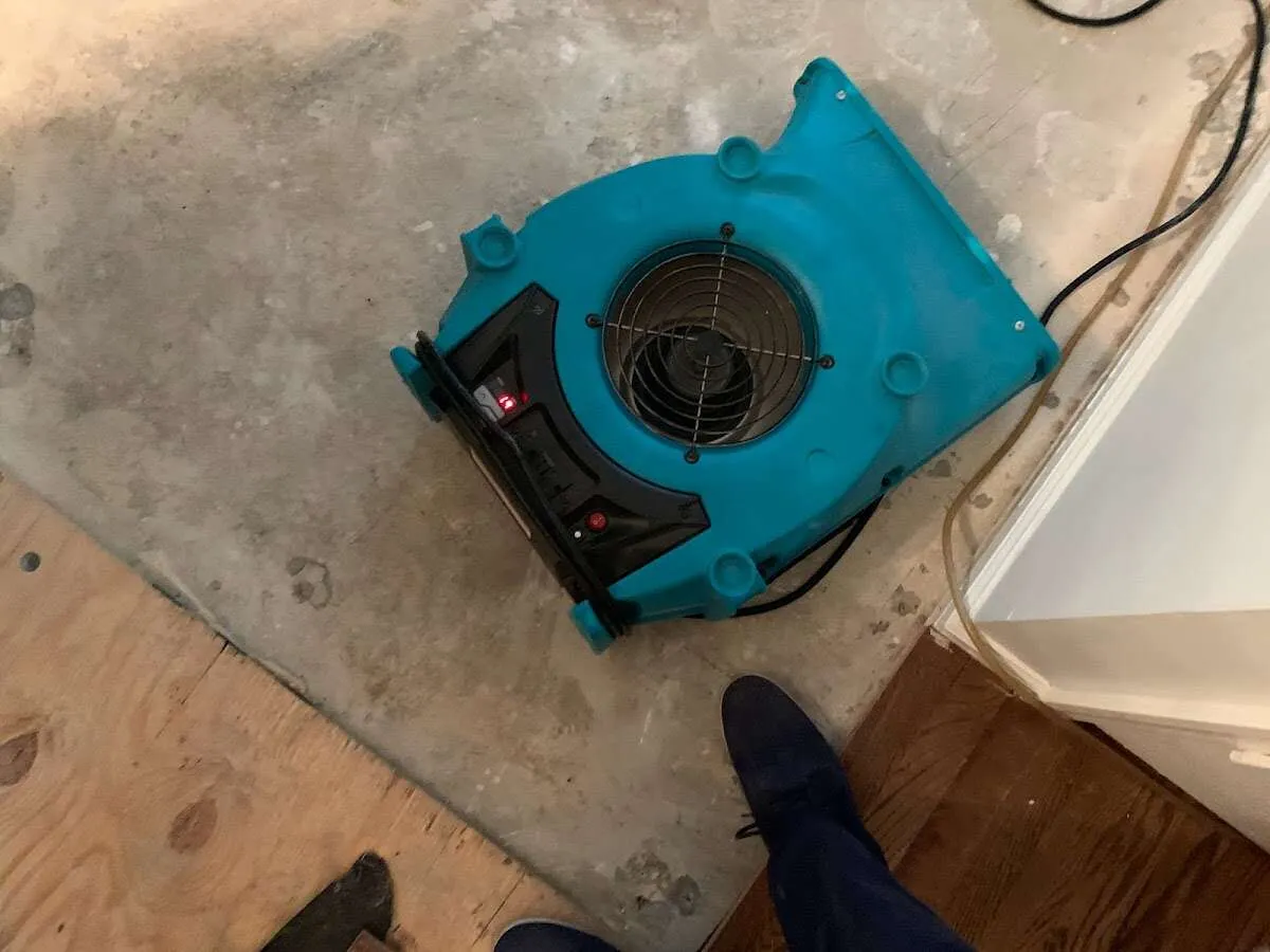 Air mover drying subfloor during Leak Detection & Repair in Reedsburg